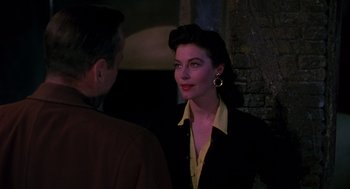 Movie still from “The Barefoot Contessa” (1954), directed by Joseph L. Mankiewicz – A man and a woman are standing next to each other; Close Up shot, Over the shoulder angle