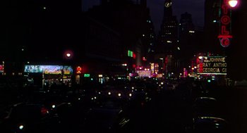 Movie still from “The Barefoot Contessa” (1954), directed by Joseph L. Mankiewicz – A city street filled with lots of traffic at night; Extreme Wide shot, High angle
