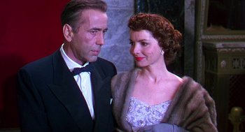 Movie still from “The Barefoot Contessa” (1954), directed by Joseph L. Mankiewicz – An older man in a tuxedo and a woman in a dress; Close Up shot, Low angle