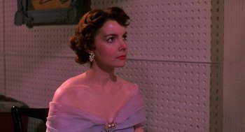 Movie still from “The Barefoot Contessa” (1954), directed by Joseph L. Mankiewicz – A woman in a purple dress looking to her left; Close Up shot, Low angle