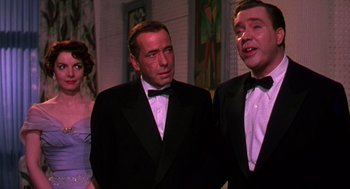Movie still from “The Barefoot Contessa” (1954), directed by Joseph L. Mankiewicz – Two men in tuxedos standing next to each other; Medium shot, Over the shoulder angle