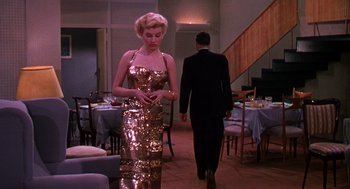 Movie still from “The Barefoot Contessa” (1954), directed by Joseph L. Mankiewicz – A man and a woman are walking through a room; Wide shot, Low angle