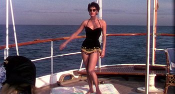 Movie still from “The Barefoot Contessa” (1954), directed by Joseph L. Mankiewicz – A woman standing on the deck of a boat in the ocean; Wide shot, Low angle