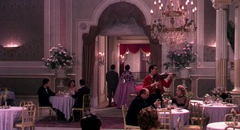 Movie still from “The Barefoot Contessa” (1954), directed by Joseph L. Mankiewicz – A group of people sitting at a table in a room; Wide shot, High angle