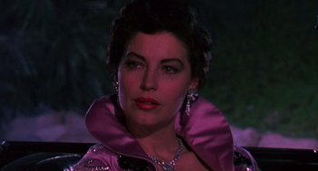 Movie still from “The Barefoot Contessa” (1954), directed by Joseph L. Mankiewicz – A person wearing a pink jacket; Close Up shot, Low angle