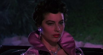 Movie still from “The Barefoot Contessa” (1954), directed by Joseph L. Mankiewicz – A person wearing a purple jacket; Close Up shot, Over the shoulder angle