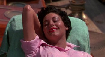 Movie still from “The Barefoot Contessa” (1954), directed by Joseph L. Mankiewicz – A woman in a pink shirt laying on the ground; Close Up shot, High angle