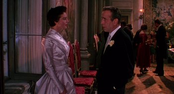 Movie still from “The Barefoot Contessa” (1954), directed by Joseph L. Mankiewicz – A man and a woman standing next to each other; Medium shot, Over the shoulder angle