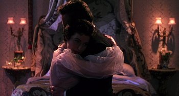 Movie still from “The Barefoot Contessa” (1954), directed by Joseph L. Mankiewicz – A man and a woman hugging in a room; Medium shot, High angle