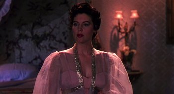 Movie still from “The Barefoot Contessa” (1954), directed by Joseph L. Mankiewicz – A woman in a pink dress with a sequin necklace; Close Up shot, Over the shoulder angle
