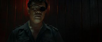 Movie still from “The Beach” (2000), directed by Danny Boyle – A man wearing a black shirt and a black eyepatch; Close Up shot, Over the shoulder angle