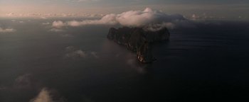 Movie still from “The Beach” (2000), directed by Danny Boyle – An aerial view of a body of water with a mountain in the background; Extreme Wide shot, Overhead angle