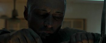 Movie still from “The Beach” (2000), directed by Danny Boyle – A man's face in the dark; Close Up shot, Low angle