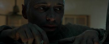 Movie still from “The Beach” (2000), directed by Danny Boyle – A person with his hand under his chin; Close Up shot, Over the shoulder angle