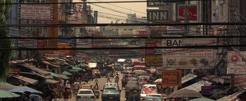 Movie still from “The Beach” (2000), directed by Danny Boyle – A busy street filled with lots of traffic; Extreme Wide shot, High angle
