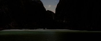 Movie still from “The Beach” (2000), directed by Danny Boyle – A view of a body of water with a moon in the background; Extreme Wide shot, High angle
