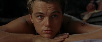 Movie still from “The Beach” (2000), directed by Danny Boyle – A person with his hand on his chest; Close Up shot, High angle
