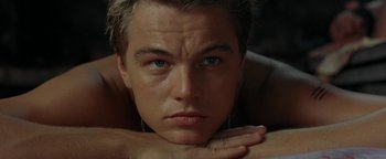 Movie still from “The Beach” (2000), directed by Danny Boyle – A person with his hand on his chin; Close Up shot, Low angle