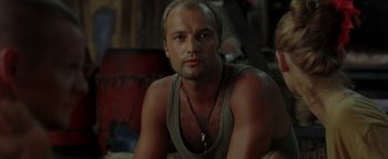 Movie still from “The Beach” (2000), directed by Danny Boyle – A person sitting on the ground; Close Up shot, Low angle