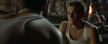 Movie still from “The Beach” (2000), directed by Danny Boyle – A person sitting in front of another person; Close Up shot, Over the shoulder angle