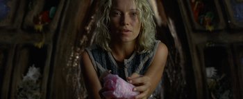 Movie still from “The Beach” (2000), directed by Danny Boyle – A woman holding a pink piece of paper in her hands; Close Up shot, Overhead angle