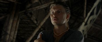 Movie still from “The Beach” (2000), directed by Danny Boyle – A person wearing a necklace; Close Up shot, High angle