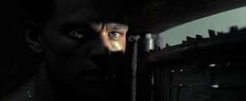 Movie still from “The Beach” (2000), directed by Danny Boyle – A person's face with a dark background; Extreme Close Up shot, Low angle