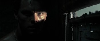 Movie still from “The Beach” (2000), directed by Danny Boyle – A person's face in the dark; Close Up shot, Low angle