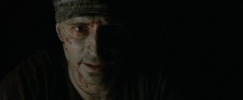 Movie still from “The Beach” (2000), directed by Danny Boyle – A person with a face covered in blood; Extreme Close Up shot, Low angle
