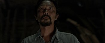 Movie still from “The Beach” (2000), directed by Danny Boyle – A person with a beard; Close Up shot, Low angle