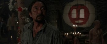 Movie still from “The Beach” (2000), directed by Danny Boyle – A person wearing a shirt; Medium shot, Over the shoulder angle