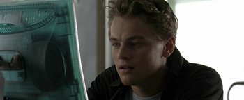 Movie still from “The Beach” (2000), directed by Danny Boyle – A young man looking at a computer screen; Close Up shot, Over the shoulder angle