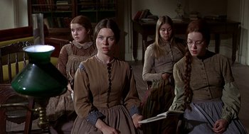 Movie still from “The Beguiled” (1971), directed by Don Siegel – A group of young women sitting next to each other in a living room; Medium shot, High angle