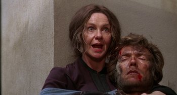 Movie still from “The Beguiled” (1971), directed by Don Siegel – A woman is holding a man's head in a room; Close Up shot, Low angle