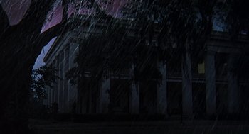 Movie still from “The Beguiled” (1971), directed by Don Siegel – A large building with trees in front of it at night time; Extreme Wide shot, Low angle