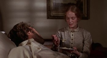 Movie still from “The Beguiled” (1971), directed by Don Siegel – A man and a woman are eating food together; Close Up shot, Over the shoulder angle