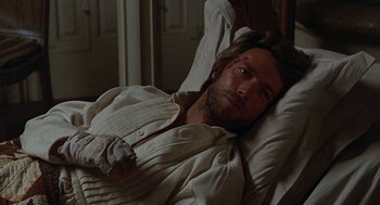 Movie still from “The Beguiled” (1971), directed by Don Siegel – A man laying in a bed with a bandage on his face; Close Up shot, High angle