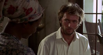 Movie still from “The Beguiled” (1971), directed by Don Siegel – A man in a white dress shirt is looking at a woman in a white dress shirt; Close Up shot, Over the shoulder angle