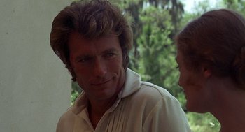 Movie still from “The Beguiled” (1971), directed by Don Siegel – A person wearing a white shirt near trees; Close Up shot, Over the shoulder angle