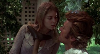Movie still from “The Beguiled” (1971), directed by Don Siegel – A man and a woman face to face with an axe; Close Up shot, Over the shoulder angle