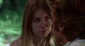Movie still from “The Beguiled” (1971), directed by Don Siegel – A young woman looking at the camera while a man looks at her face; Close Up shot, Over the shoulder angle