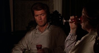 Movie still from “The Beguiled” (1971), directed by Don Siegel – A man holding a glass of wine and looking at another man holding a wine glass; Close Up shot, Over the shoulder angle