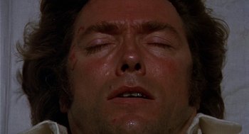 Movie still from “The Beguiled” (1971), directed by Don Siegel – A man's face with blood on his face; Extreme Close Up shot, Overhead angle