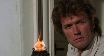 Movie still from “The Beguiled” (1971), directed by Don Siegel – A person near a fire flame; Close Up shot, Low angle