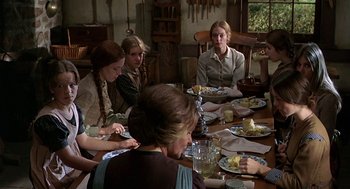 Movie still from “The Beguiled” (1971), directed by Don Siegel – A group of people sitting at a table with plates of food on it; Medium shot, High angle