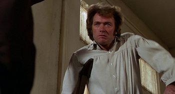 Movie still from “The Beguiled” (1971), directed by Don Siegel – A person holding a gun in a room; Close Up shot, Low angle