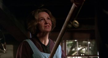 Movie still from “The Beguiled” (1971), directed by Don Siegel – A woman holding a wooden stick in a room; Close Up shot, Low angle
