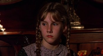 Movie still from “The Beguiled” (1971), directed by Don Siegel – A young girl with long braids wearing a dress; Close Up shot, Over the shoulder angle