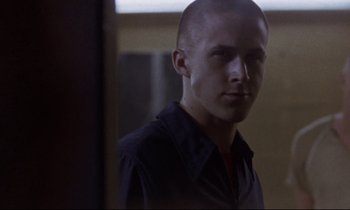 Movie still from “The Believer” (2001), directed by Henry Bean – A man with a shaved head looking at a mirror; Close Up shot, Over the shoulder angle
