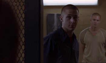 Movie still from “The Believer” (2001), directed by Henry Bean – A young man standing in front of a bathroom mirror; Medium shot, Over the shoulder angle